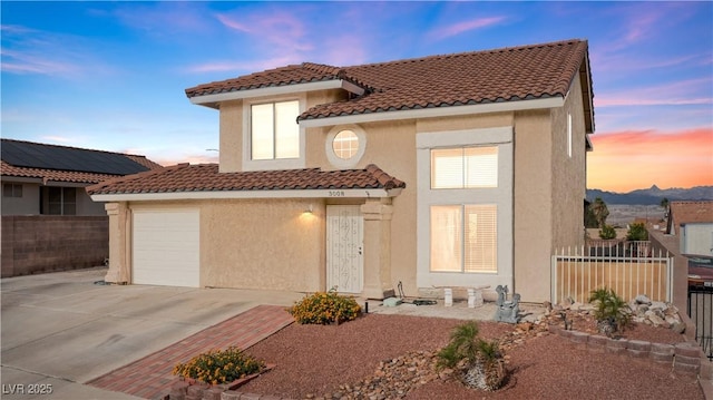 3008 Soledad Dr, Laughlin, NV 89029 - mediterranean / spanish house with a tile roof, driveway, stucco siding, and a garage