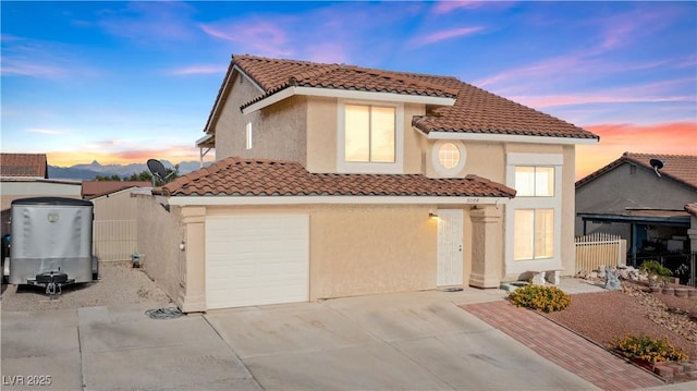 3008 Soledad Dr, Laughlin, NV 89029 - mediterranean / spanish home featuring a tile roof, stucco siding, driveway, and an attached garage