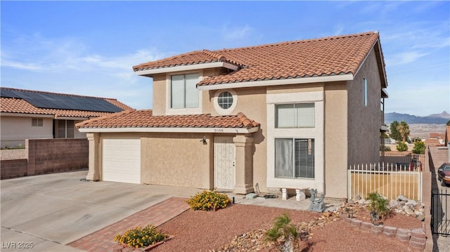 3008 Soledad Dr, Laughlin, NV 89029 - view of front of home featuring concrete driveway, a tile roof, stucco siding, a garage, and a mountain view