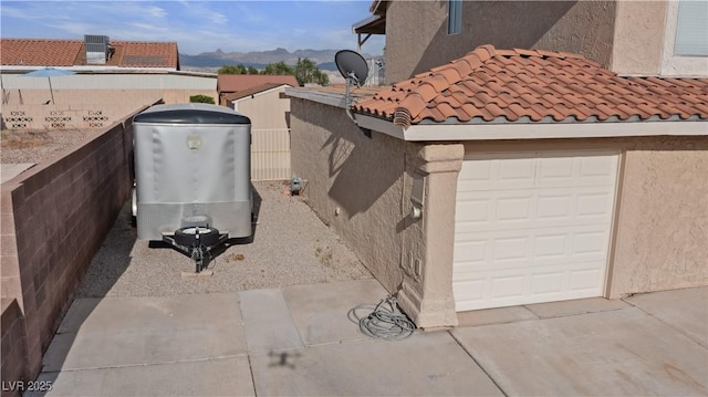 3008 Soledad Dr, Laughlin, NV 89029 - exterior view of stucco siding, mountains, a satellite dish, and a tile roof