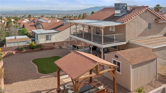 3008 Soledad Dr, Laughlin, NV 89029 - back of house featuring a balcony, a mountain view, a tiled roof, central AC, and a residential view