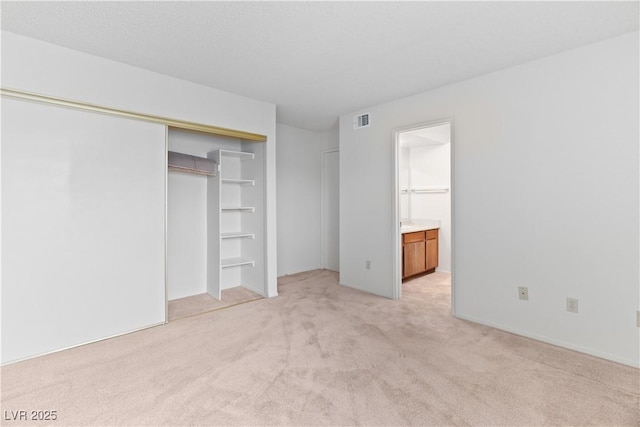 3740 Desert Marina Dr Unit 2, Laughlin, NV 89029 - unfurnished bedroom with light colored carpet, a closet, and ensuite bath