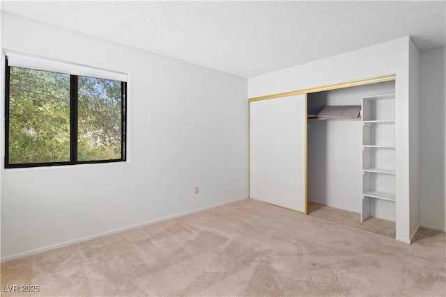3740 Desert Marina Dr Unit 2, Laughlin, NV 89029 - unfurnished bedroom featuring carpet, a textured ceiling, and a closet