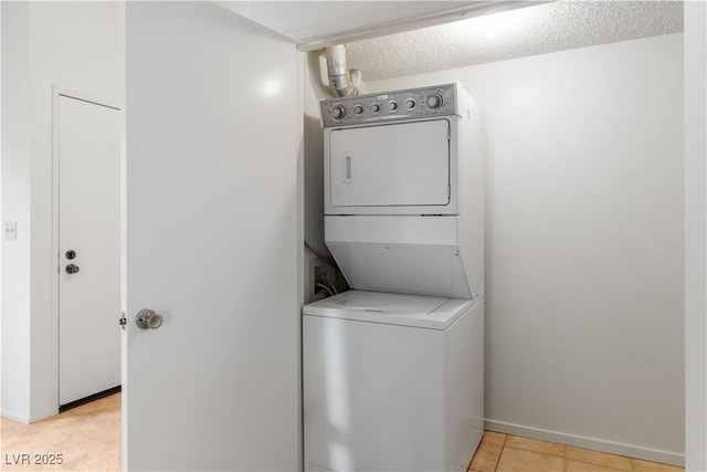 3740 Desert Marina Dr Unit 2, Laughlin, NV 89029 - laundry room featuring stacked washing machine and dryer and baseboards