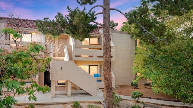 3740 Desert Marina Dr Unit 2, Laughlin, NV 89029 - back of house with stairs, stucco siding, a tile roof, and a balcony
