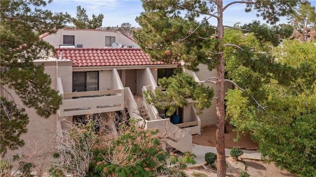 3740 Desert Marina Dr Unit 2, Laughlin, NV 89029 - back of house featuring a tile roof, stucco siding, and stairway