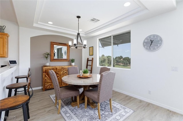 9112 Vista Greens Way Unit 204, Las Vegas, NV 89134 - dining space with a chandelier, a raised ceiling, light wood-style flooring, recessed lighting, and baseboards