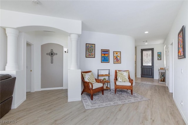 9112 Vista Greens Way Unit 204, Las Vegas, NV 89134 - sitting room featuring light wood-type flooring, ornate columns, arched walkways, baseboards, and recessed lighting