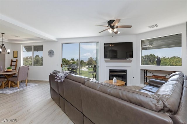 9112 Vista Greens Way Unit 204, Las Vegas, NV 89134 - living room with light wood-style floors, a ceiling fan, a fireplace, and baseboards