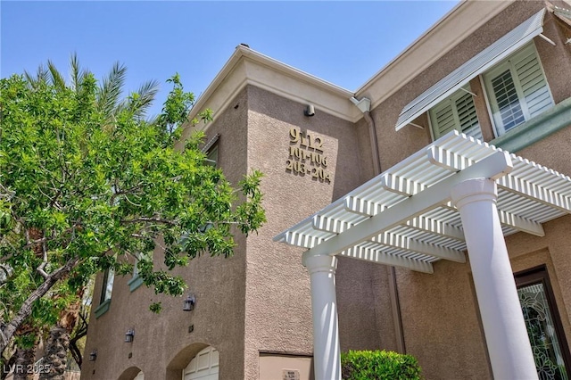 9112 Vista Greens Way Unit 204, Las Vegas, NV 89134 - view of property exterior featuring a pergola and stucco siding