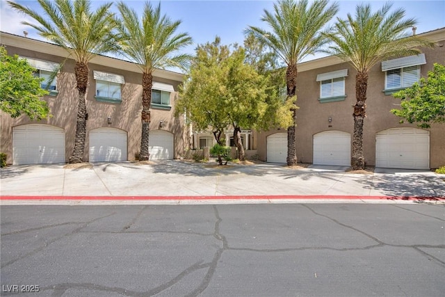 9112 Vista Greens Way Unit 204, Las Vegas, NV 89134 - view of property featuring stucco siding and a garage