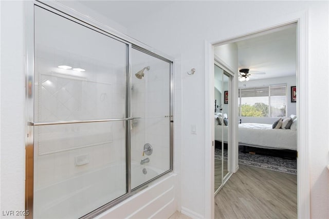 9112 Vista Greens Way Unit 204, Las Vegas, NV 89134 - full bath featuring ensuite bath, enclosed tub / shower combo, a ceiling fan, wood finished floors, and baseboards