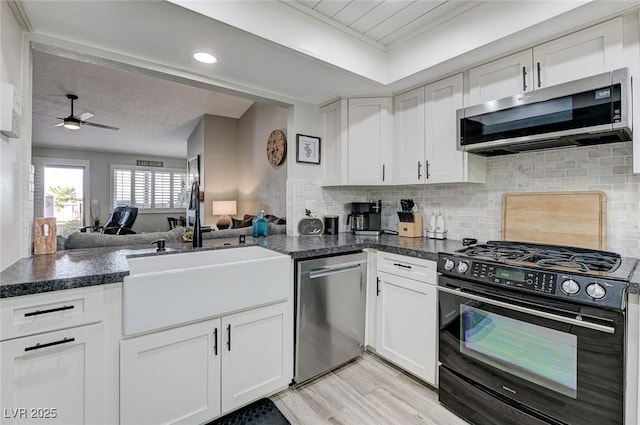 450 Intrepid Ct, Boulder City, NV 89005 - kitchen with stainless steel appliances, a ceiling fan, white cabinets, and recessed lighting