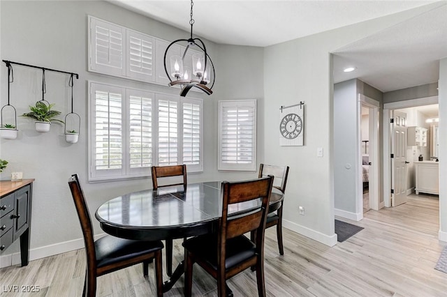 450 Intrepid Ct, Boulder City, NV 89005 - dining area with a chandelier, baseboards, and light wood finished floors