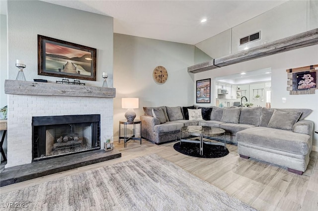 450 Intrepid Ct, Boulder City, NV 89005 - living area with wood finished floors, lofted ceiling, a brick fireplace, and recessed lighting