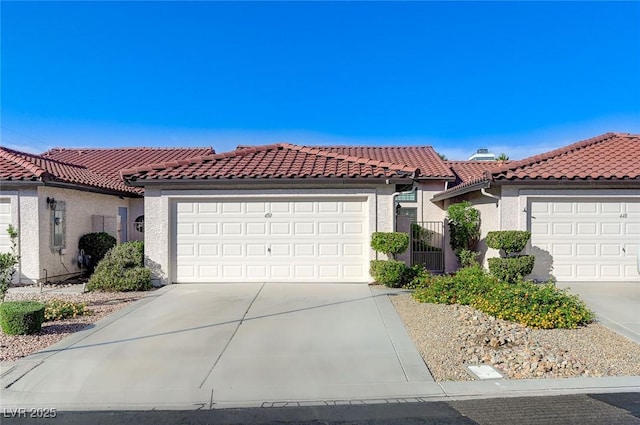 450 Intrepid Ct, Boulder City, NV 89005 - mediterranean / spanish house featuring a tile roof, concrete driveway, and an attached garage