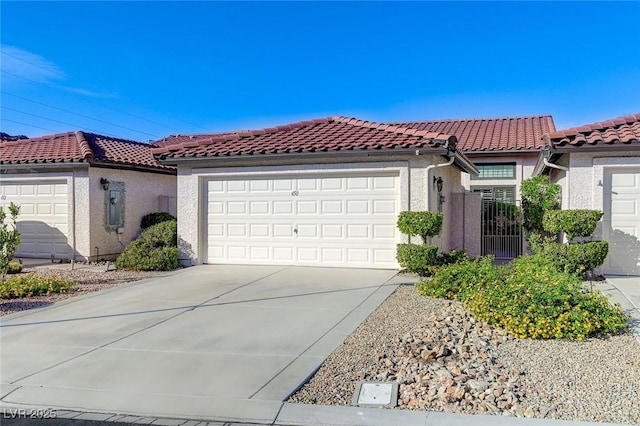 450 Intrepid Ct, Boulder City, NV 89005 - mediterranean / spanish-style home with stucco siding, driveway, an attached garage, and a tile roof