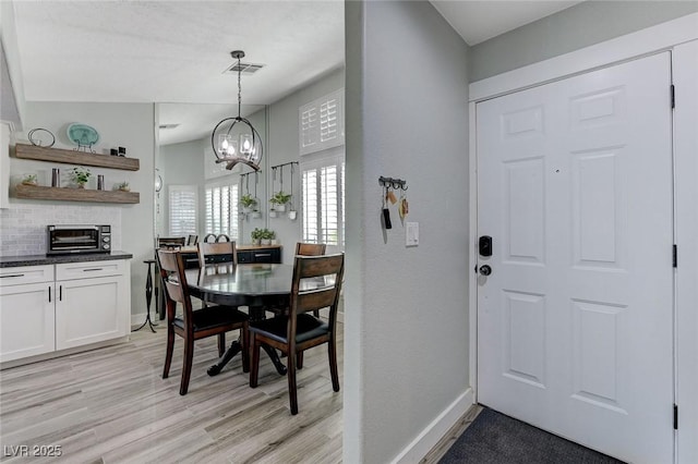450 Intrepid Ct, Boulder City, NV 89005 - dining area with a chandelier, light wood-style flooring, and baseboards