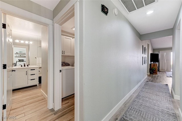 450 Intrepid Ct, Boulder City, NV 89005 - hall featuring light wood-style floors, baseboards, and separate washer and dryer