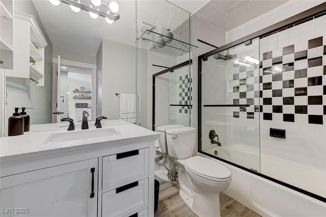 450 Intrepid Ct, Boulder City, NV 89005 - bathroom featuring vanity, toilet, bath / shower combo with glass door, and wood finished floors