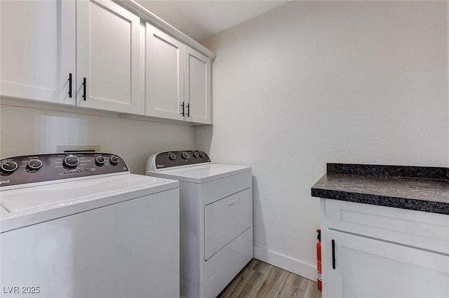450 Intrepid Ct, Boulder City, NV 89005 - laundry room featuring cabinet space, washing machine and clothes dryer, light wood-type flooring, and baseboards