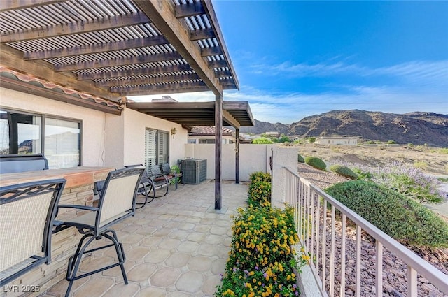 450 Intrepid Ct, Boulder City, NV 89005 - view of patio / terrace with a mountain view, a pergola, and central AC