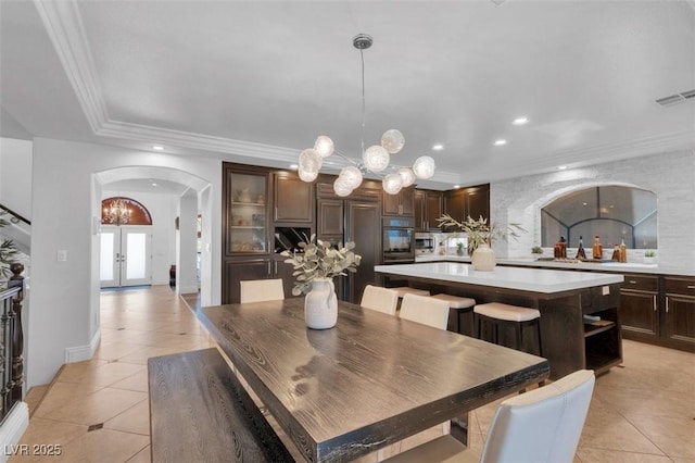 4108 Royal Scots Ave, Las Vegas, NV 89141 - dining room with arched walkways, light tile patterned flooring, a chandelier, recessed lighting, and french doors