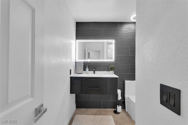 4108 Royal Scots Ave, Las Vegas, NV 89141 - bathroom featuring toilet, vanity, a textured wall, and tile patterned flooring