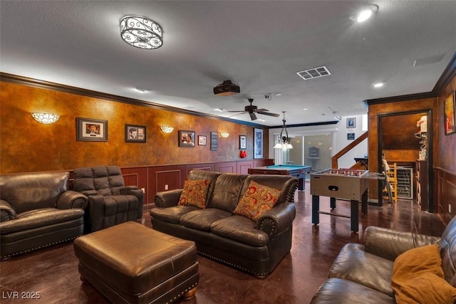4108 Royal Scots Ave, Las Vegas, NV 89141 - home theater room with ornamental molding, billiards, a ceiling fan, a wainscoted wall, and finished concrete floors