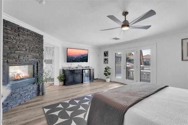 4108 Royal Scots Ave, Las Vegas, NV 89141 - bedroom with access to outside, ornamental molding, bar, light wood finished floors, and beverage cooler