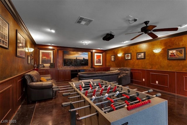 4108 Royal Scots Ave, Las Vegas, NV 89141 - cinema room with ornamental molding, a ceiling fan, a decorative wall, and wainscoting