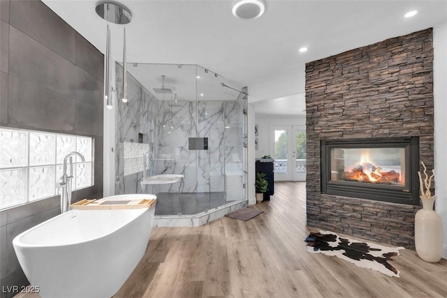 4108 Royal Scots Ave, Las Vegas, NV 89141 - bathroom with a marble finish shower, a soaking tub, wood finished floors, recessed lighting, and a fireplace