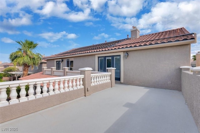4108 Royal Scots Ave, Las Vegas, NV 89141 - back of property with a tiled roof, a chimney, stucco siding, and french doors