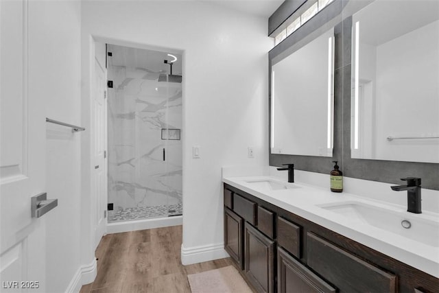 4108 Royal Scots Ave, Las Vegas, NV 89141 - bathroom featuring a marble finish shower, wood finished floors, double vanity, and baseboards