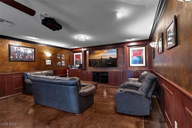 4108 Royal Scots Ave, Las Vegas, NV 89141 - home theater featuring crown molding, a decorative wall, finished concrete floors, and wainscoting