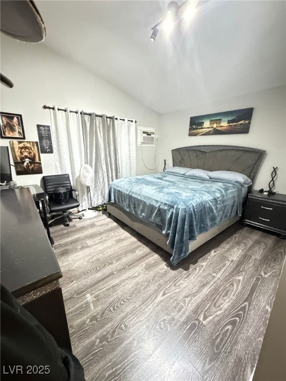 1505 Lilac Breeze Cir, Las Vegas, NV 89108 - bedroom featuring wood finished floors, vaulted ceiling, a wall mounted air conditioner, and a desk