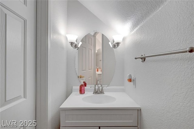 6320 Desert Leaf St Unit 101, North Las Vegas, NV 89081 - bathroom featuring vanity and a textured wall