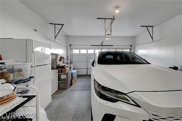 6320 Desert Leaf St Unit 101, North Las Vegas, NV 89081 - garage featuring a garage door opener and freestanding refrigerator