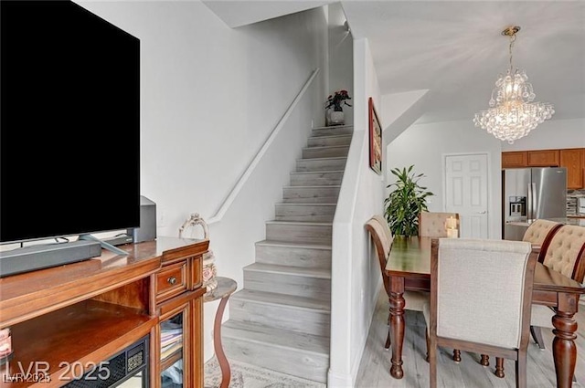 6320 Desert Leaf St Unit 101, North Las Vegas, NV 89081 - stairway featuring a chandelier and wood finished floors