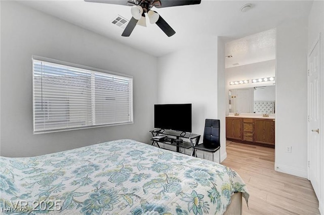 6320 Desert Leaf St Unit 101, North Las Vegas, NV 89081 - bedroom featuring light wood finished floors, a ceiling fan, baseboards, and ensuite bath