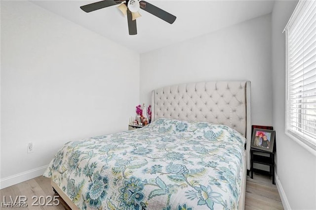6320 Desert Leaf St Unit 101, North Las Vegas, NV 89081 - bedroom with light wood finished floors, baseboards, and a ceiling fan