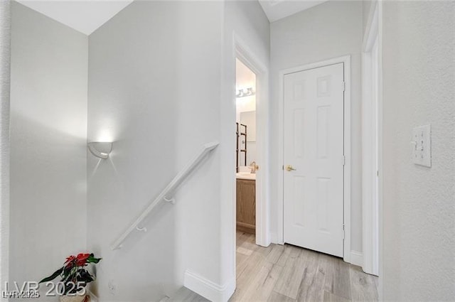 6320 Desert Leaf St Unit 101, North Las Vegas, NV 89081 - hall with light wood-style floors, an upstairs landing, and baseboards