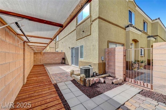 6320 Desert Leaf St Unit 101, North Las Vegas, NV 89081 - fenced backyard with cooling unit, a gate, and a patio
