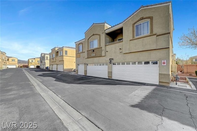 6320 Desert Leaf St Unit 101, North Las Vegas, NV 89081 - view of asphalt street with a residential view and curbs