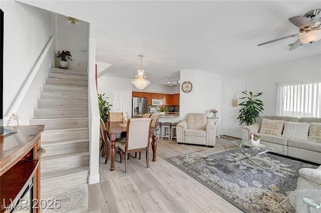 6320 Desert Leaf St Unit 101, North Las Vegas, NV 89081 - living room featuring light wood-style flooring, stairs, and ceiling fan