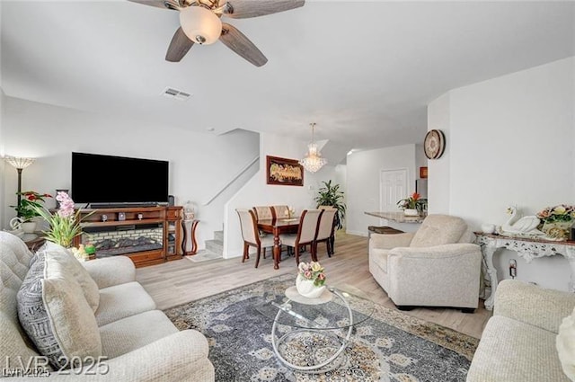 6320 Desert Leaf St Unit 101, North Las Vegas, NV 89081 - living area featuring wood finished floors, ceiling fan, and a chandelier