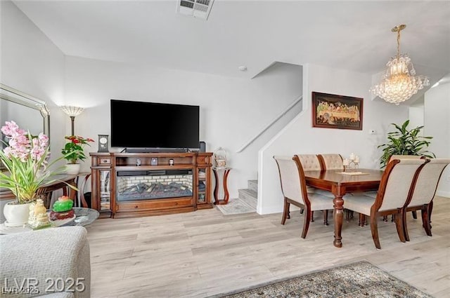6320 Desert Leaf St Unit 101, North Las Vegas, NV 89081 - dining room featuring wood finished floors, stairway, and a chandelier