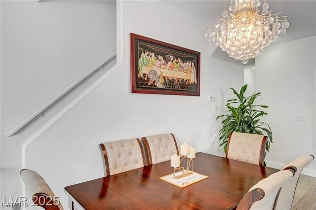 6320 Desert Leaf St Unit 101, North Las Vegas, NV 89081 - dining room featuring a chandelier, wood finished floors, and baseboards