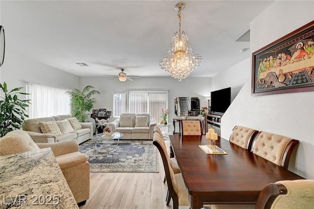 6320 Desert Leaf St Unit 101, North Las Vegas, NV 89081 - living room featuring a ceiling fan, a chandelier, and light wood finished floors