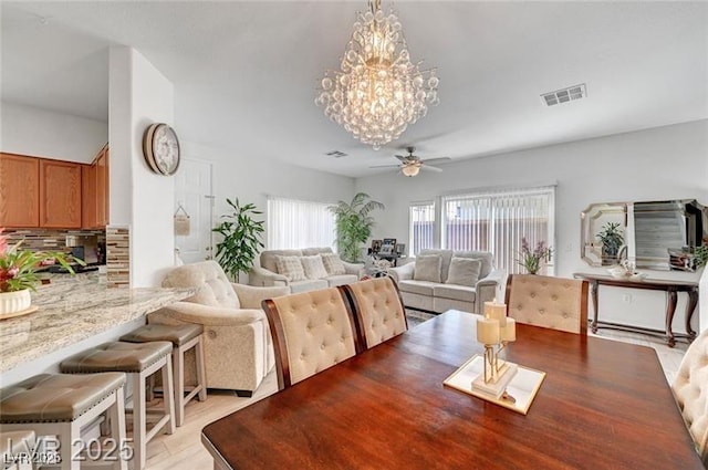 6320 Desert Leaf St Unit 101, North Las Vegas, NV 89081 - dining space with ceiling fan, a chandelier, and light wood-style flooring